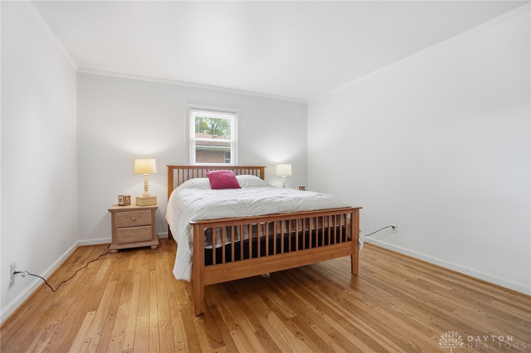 6119 Flemington Road Dayton, OH 45459 - Photo 25 of 76 Bright and airy, this sleeping space offers a tranquil retreat with beautiful wood floors.