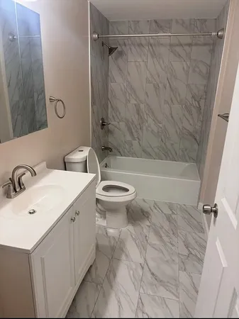 a bathroom with a sink toilet and shower