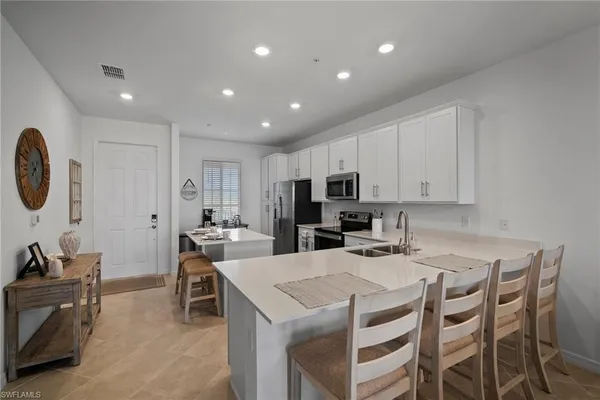 a kitchen that has a table and chairs in it