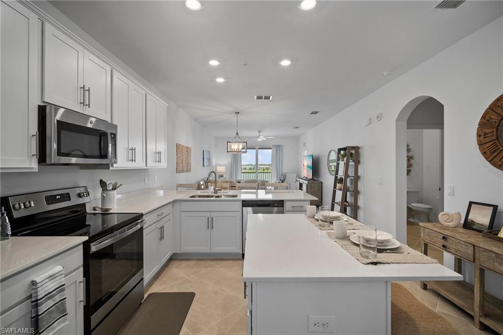 43985 Boardwalk Loop, Unit 2143 Babcock Ranch, FL 33982 - Photo 14 of 25 a kitchen with counter top space appliances and cabinets