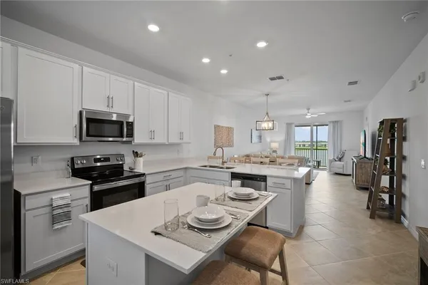 a large kitchen with a table and chairs