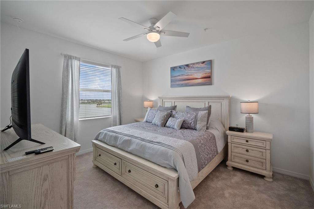 43985 Boardwalk Loop, Unit 2143 Babcock Ranch, FL 33982 - Photo 16 of 25 a bedroom with a bed and a flat screen tv