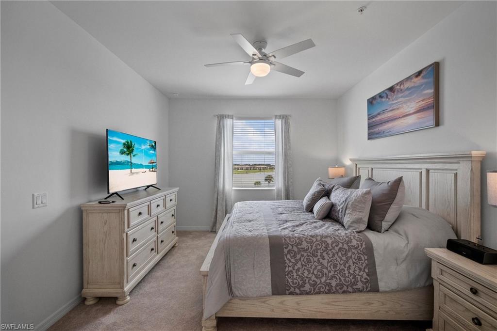 43985 Boardwalk Loop, Unit 2143 Babcock Ranch, FL 33982 - Photo 17 of 25 a bedroom with a bed and a flat screen tv