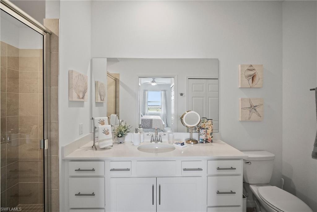43985 Boardwalk Loop, Unit 2143 Babcock Ranch, FL 33982 - Photo 19 of 25 a bathroom with a toilet sink and mirror
