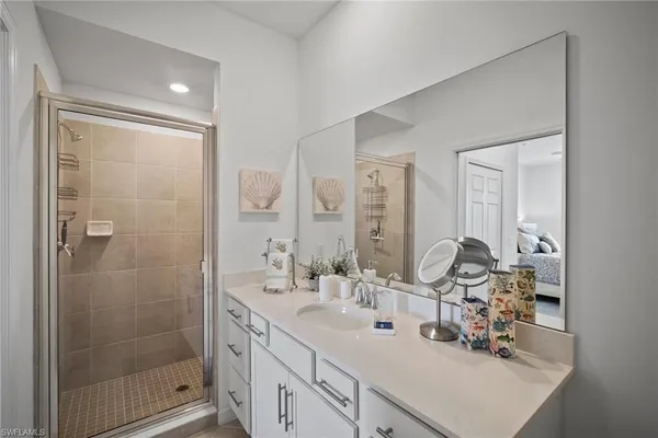 a bathroom with double vanity sink and mirror