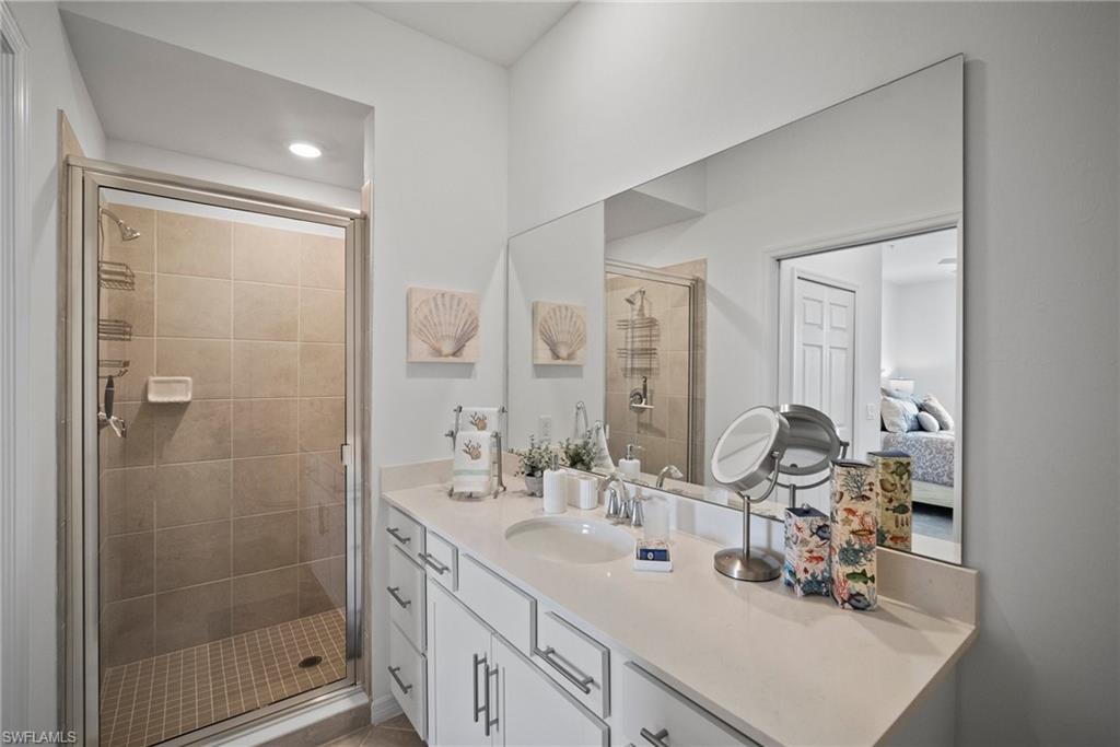 43985 Boardwalk Loop, Unit 2143 Babcock Ranch, FL 33982 - Photo 20 of 25 a bathroom with double vanity sink and mirror