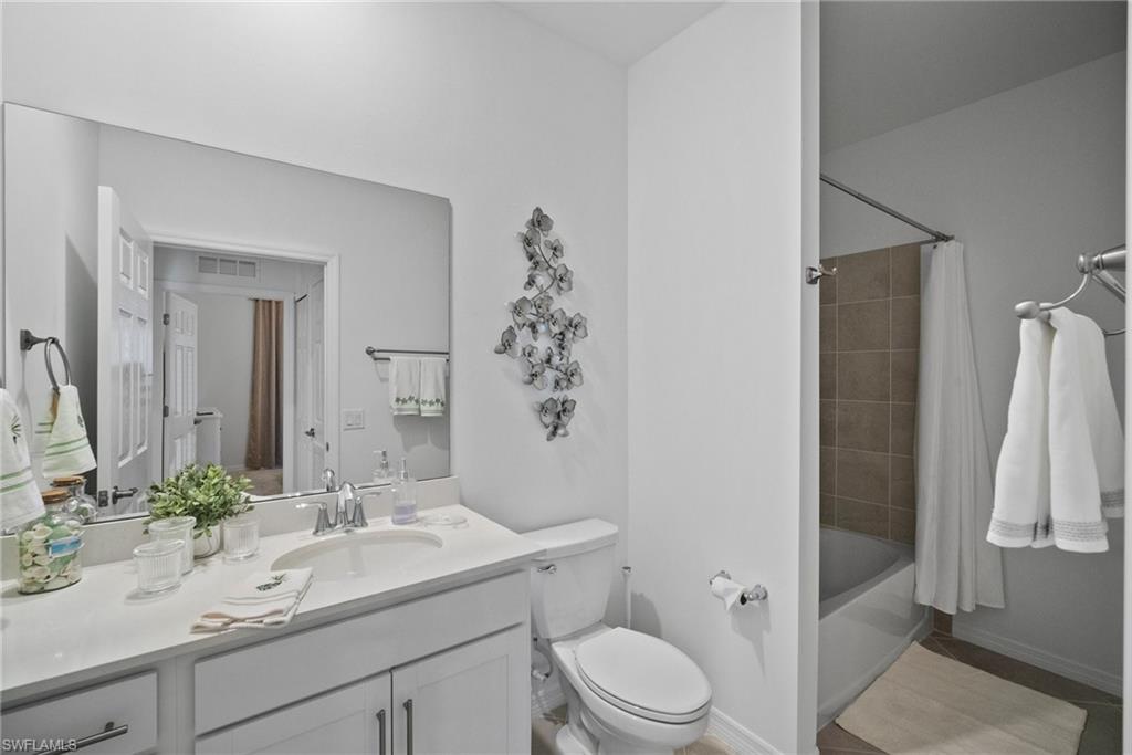 43985 Boardwalk Loop, Unit 2143 Babcock Ranch, FL 33982 - Photo 22 of 25 a bathroom with a sink a toilet and shower