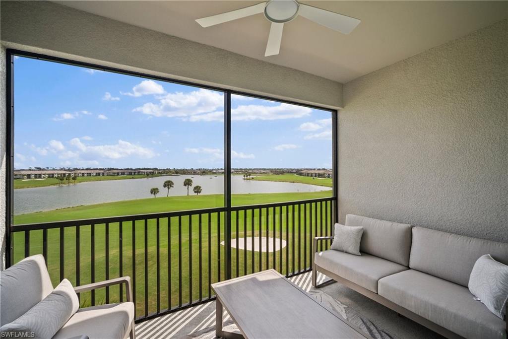 43985 Boardwalk Loop, Unit 2143 Babcock Ranch, FL 33982 - Photo 3 of 25 a living room with furniture floor to ceiling window and an outdoor view