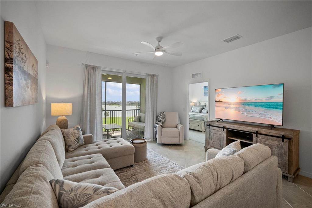 43985 Boardwalk Loop, Unit 2143 Babcock Ranch, FL 33982 - Photo 6 of 25 a living room with furniture and a flat screen tv