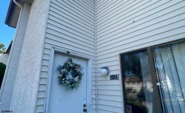 a view of a house with a potted plant and a window