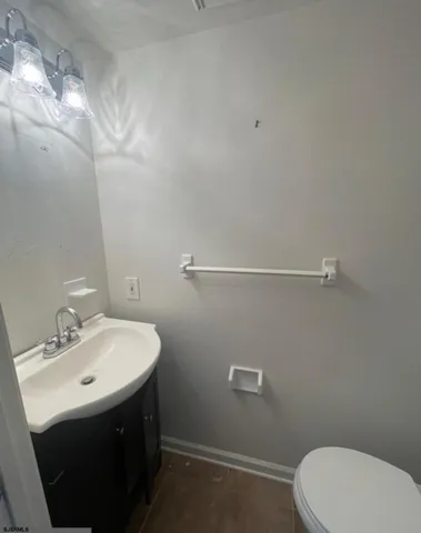 a bathroom with a sink mirror and toilet