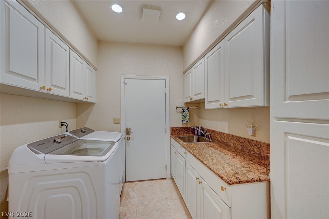7995 Rio Rico Drive Las Vegas, NV 89113 - Photo 26 of 92 Functional laundry room equipped with upper and lower cabinetry, providing ample storage for essentials.