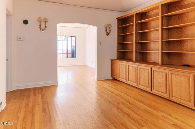 a view of empty room with wooden floor and cabinet