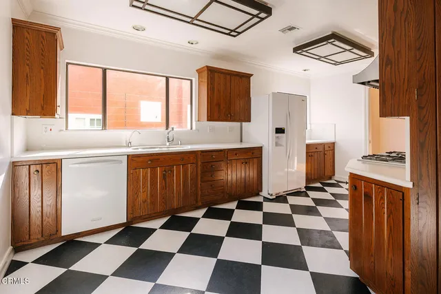 a kitchen with a stove a sink and a refrigerator