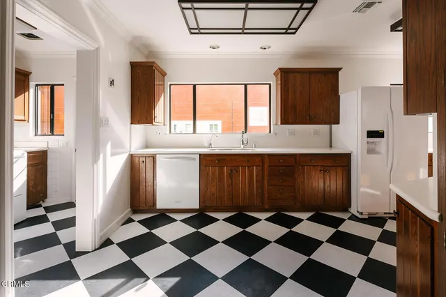 a bathroom with a granite countertop sink a toilet and shower