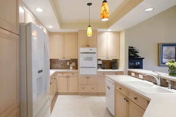 a kitchen with a refrigerator and a sink