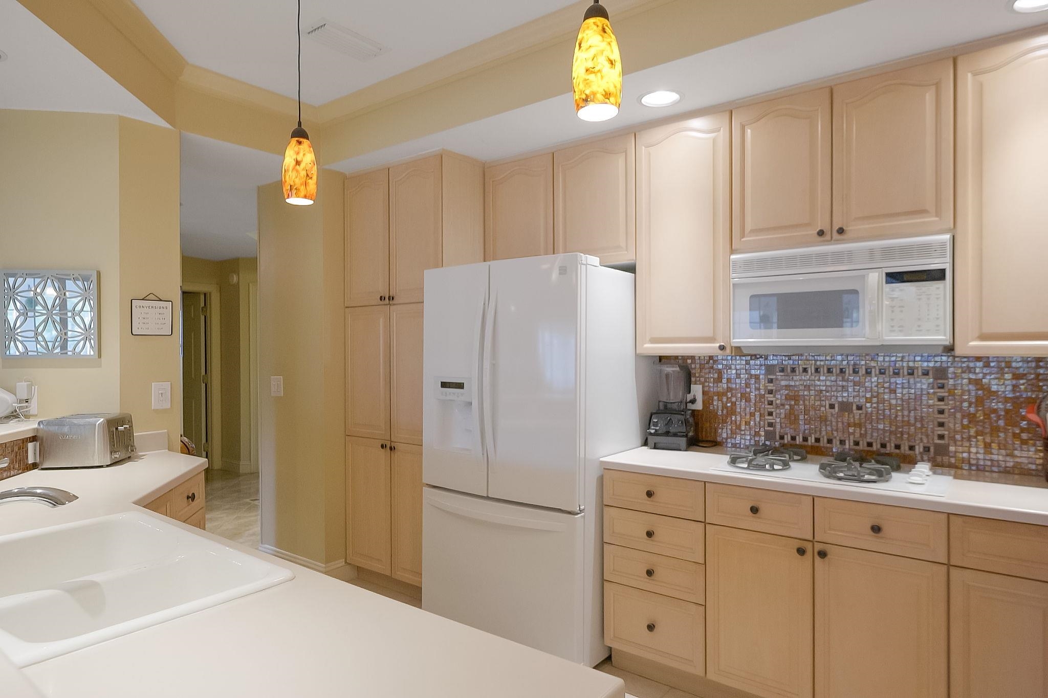 145 North Champions Way, Unit 123 St. Augustine, FL 32092 - Photo 13 of 55 a kitchen with a refrigerator and a sink