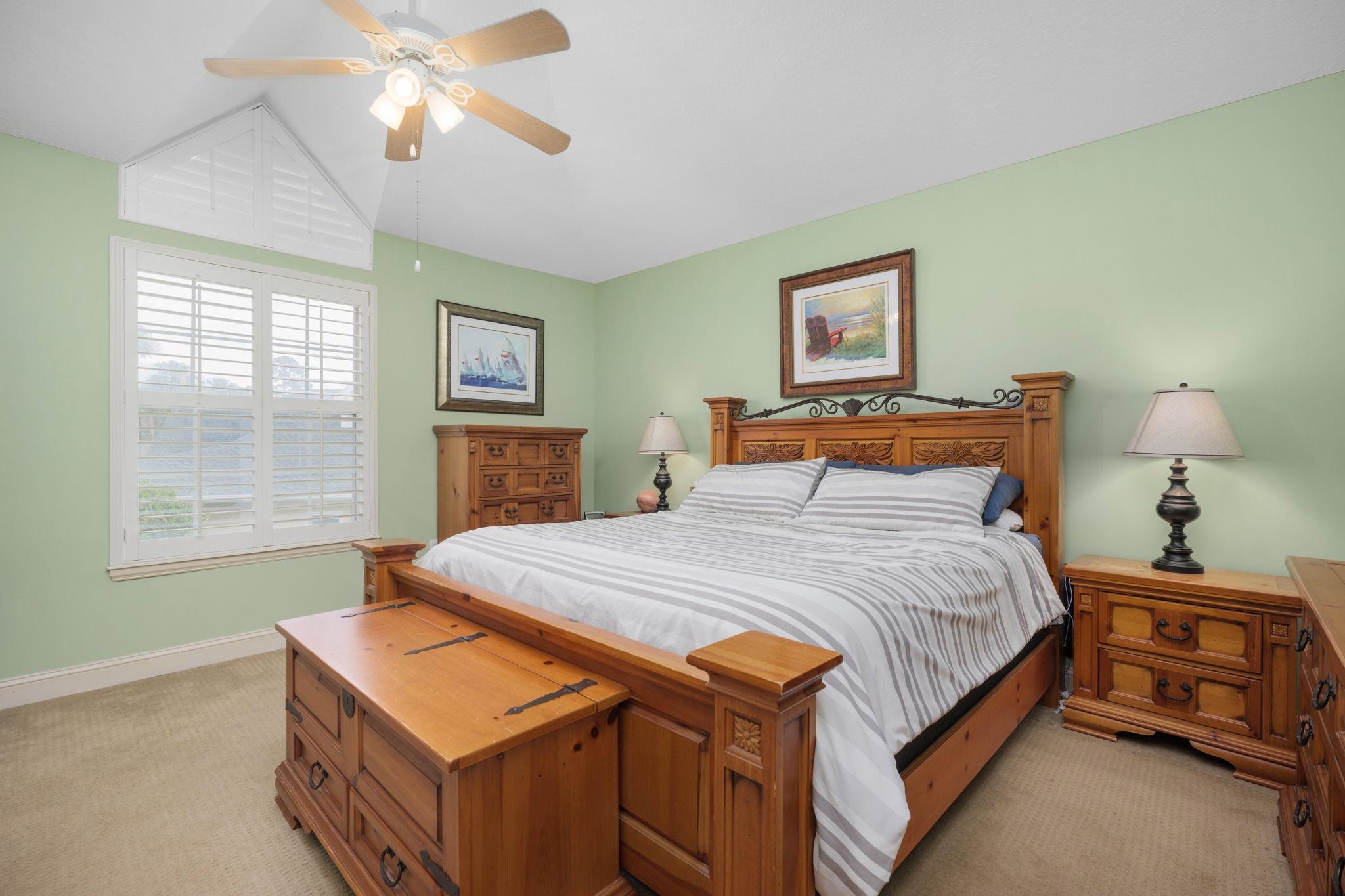145 North Champions Way, Unit 123 St. Augustine, FL 32092 - Photo 19 of 55 a bedroom with a bed and a chandelier