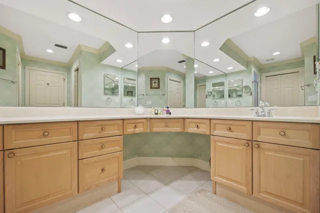 a bedroom with furniture and a mirror