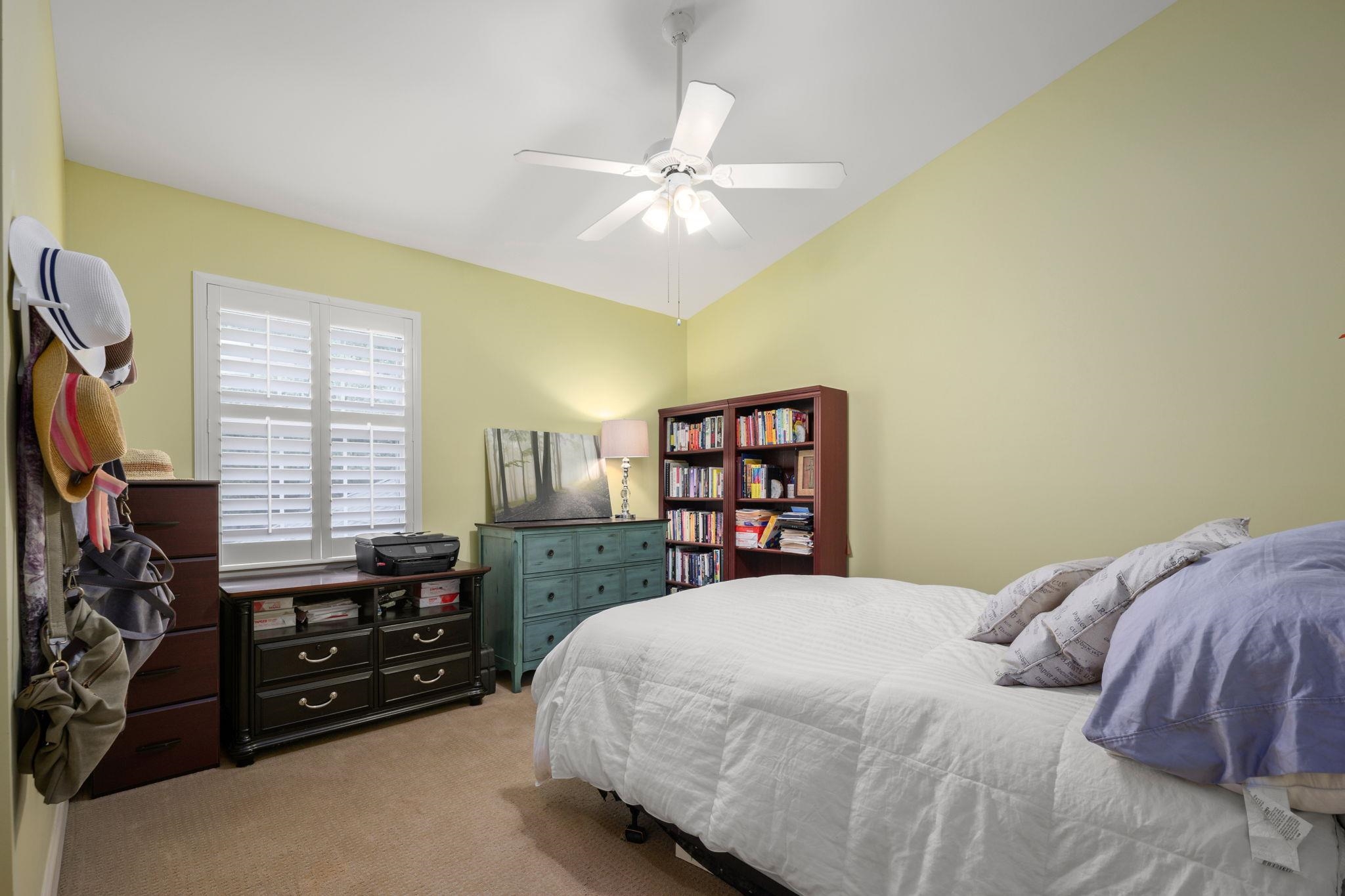 145 North Champions Way, Unit 123 St. Augustine, FL 32092 - Photo 27 of 55 a bedroom with a bed and a chandelier