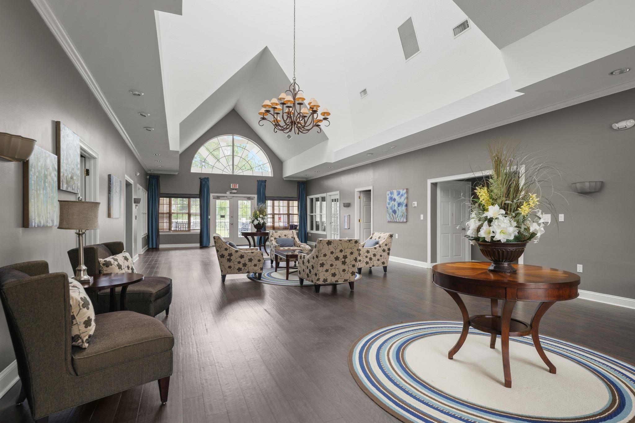 145 North Champions Way, Unit 123 St. Augustine, FL 32092 - Photo 35 of 55 a living room with furniture chandelier and a rug