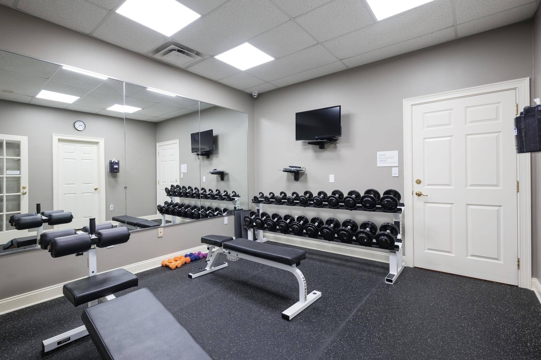 145 North Champions Way, Unit 123 St. Augustine, FL 32092 - Photo 37 of 55 a room with gym equipment and mirrors