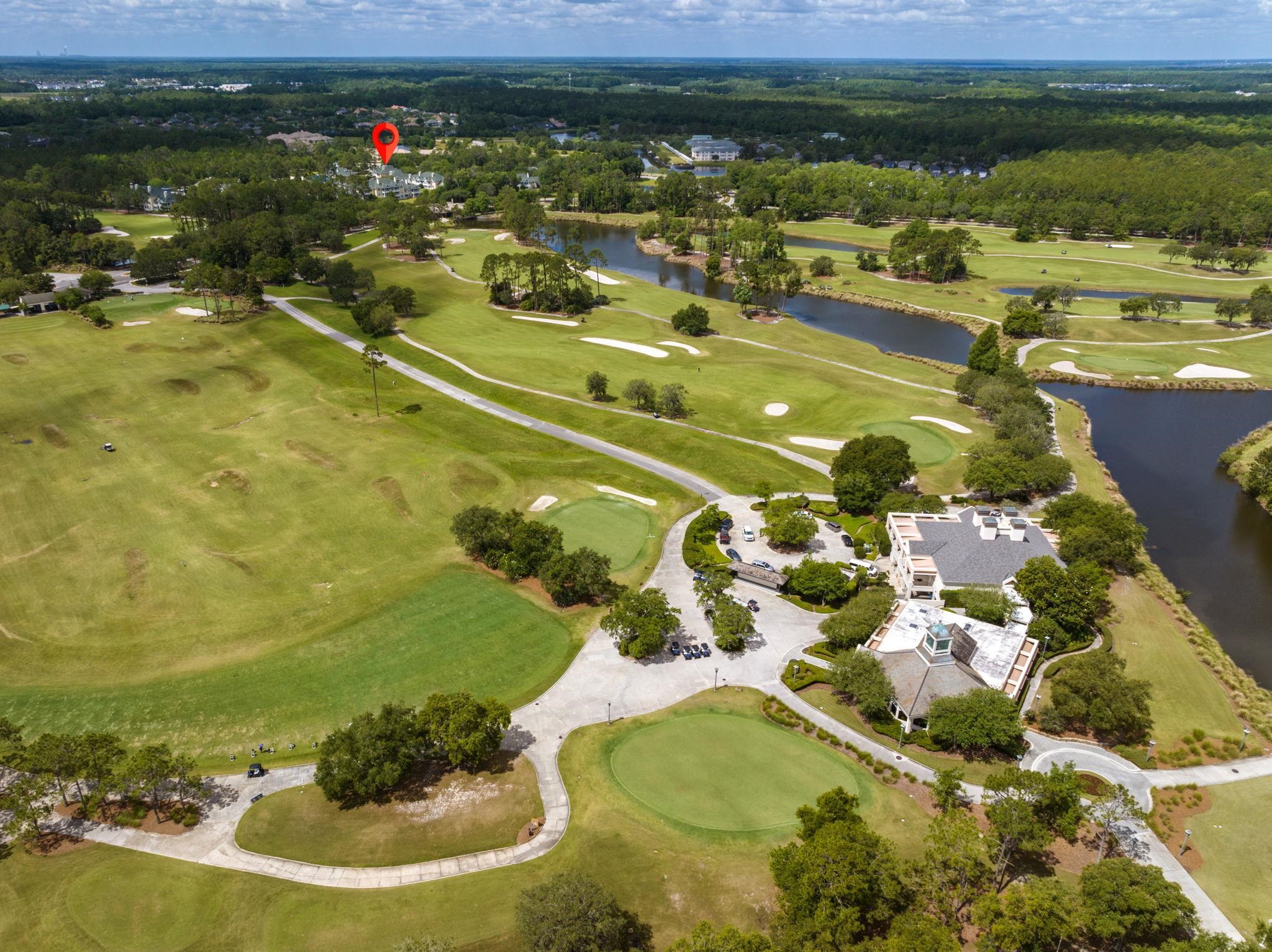 145 North Champions Way, Unit 123 St. Augustine, FL 32092 - Photo 41 of 55 a view of a swimming pool of a lake with lawn chairs
