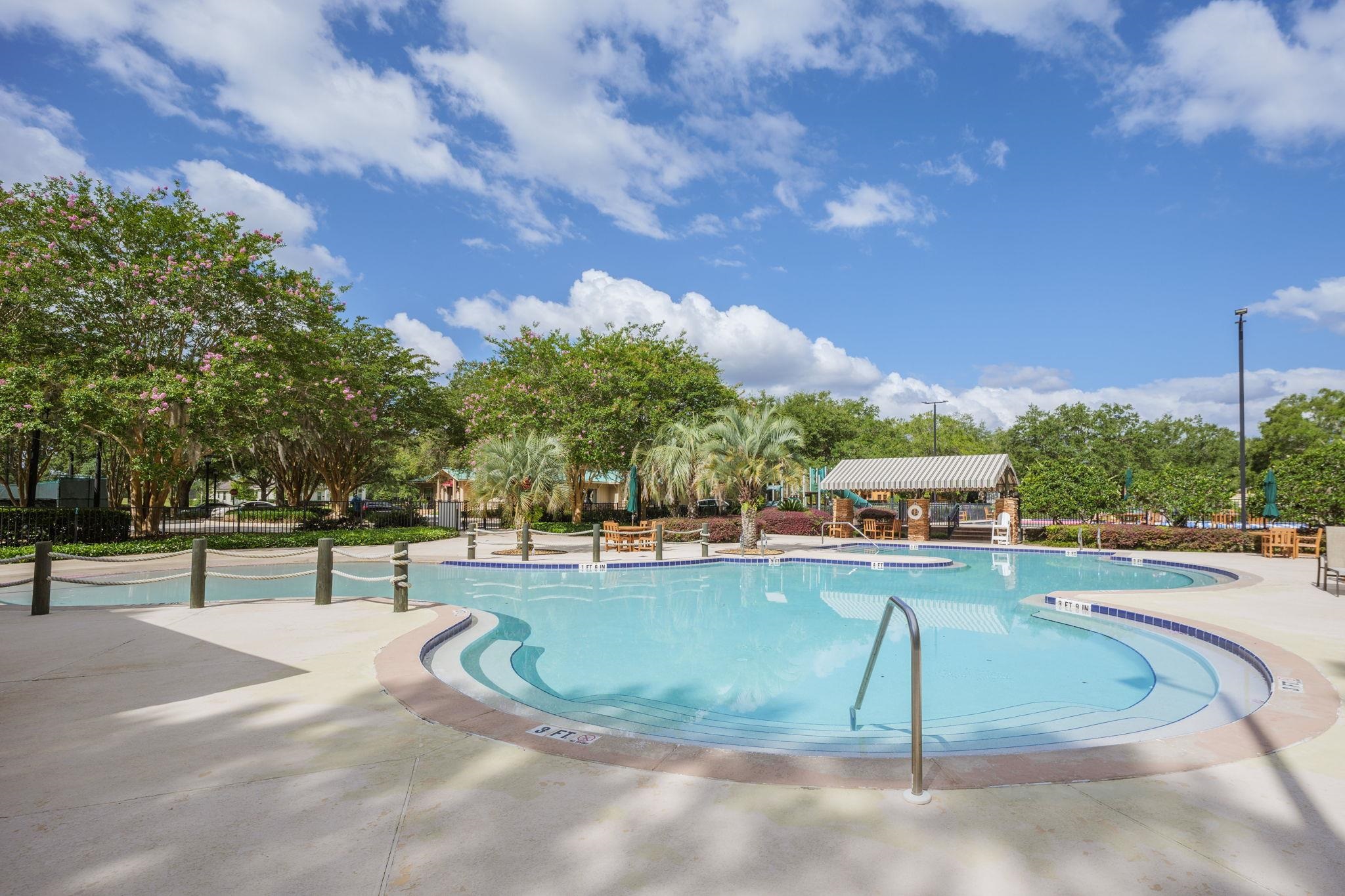 145 North Champions Way, Unit 123 St. Augustine, FL 32092 - Photo 48 of 55 a view of a swimming pool with lawn chairs and plants