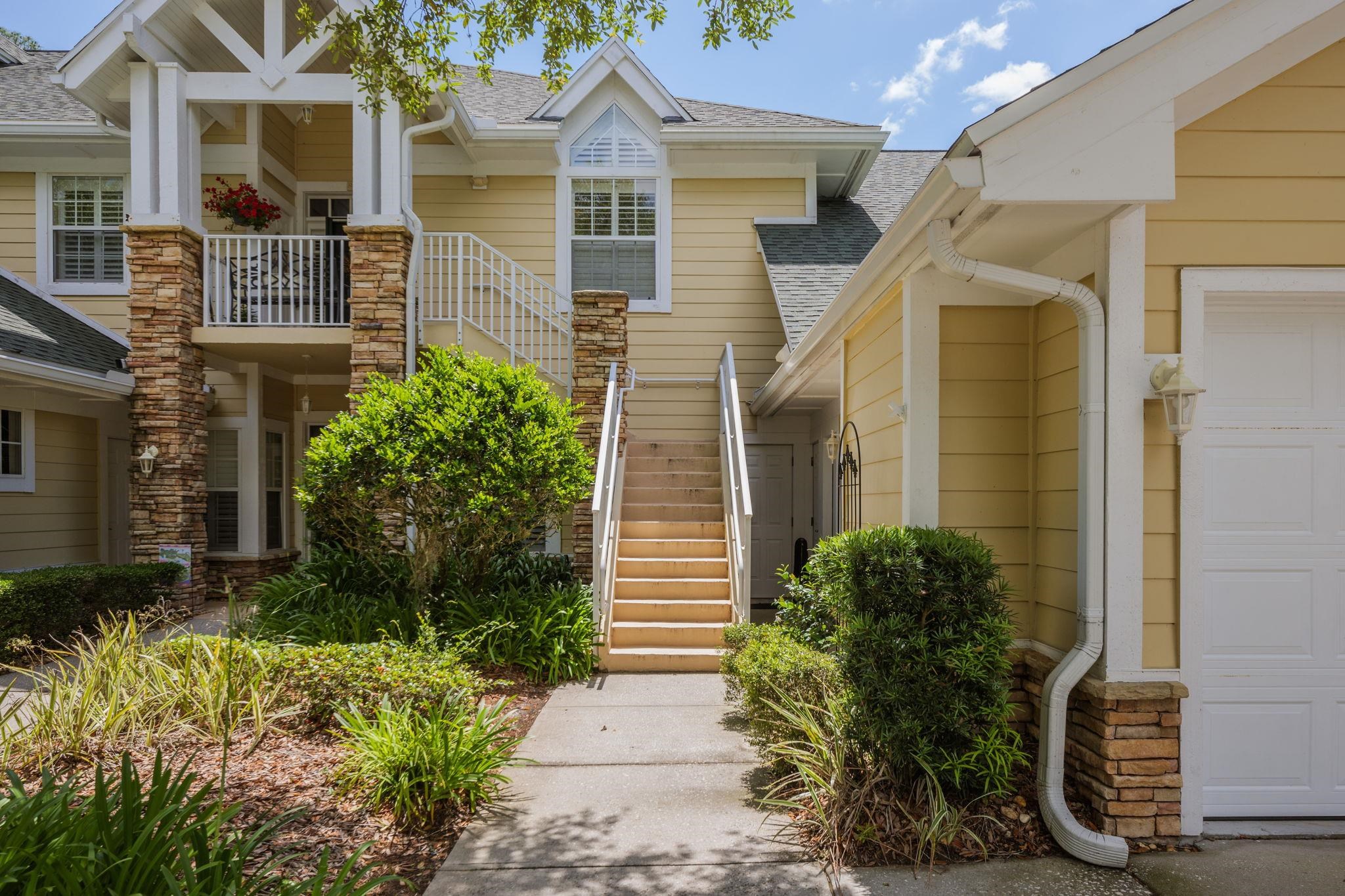 145 North Champions Way, Unit 123 St. Augustine, FL 32092 - Photo 51 of 55 a view of a brick house with plants and large windows
