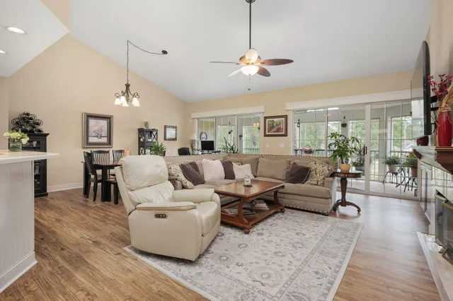 a living room with furniture wooden floor and a chandelier