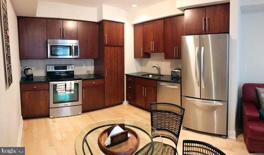 3925 Fulton Street Northwest, Unit 5 Washington, DC 20007 - Photo 6 of 19 a kitchen with stainless steel appliances granite countertop a refrigerator and a stove top oven