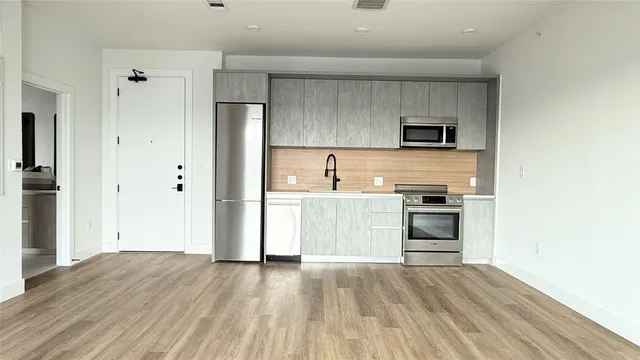 a kitchen with a sink and a stove top oven