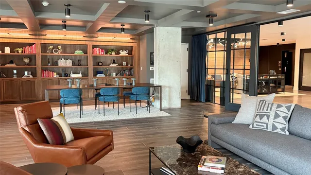 a living room with lots of furniture and a large window