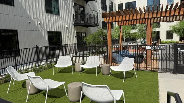 a view of a chairs and table in backyard