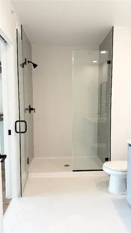 a bathroom with a shower and a toilet