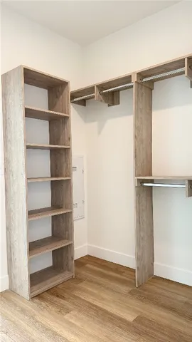 a view of walk in closet with empty racks