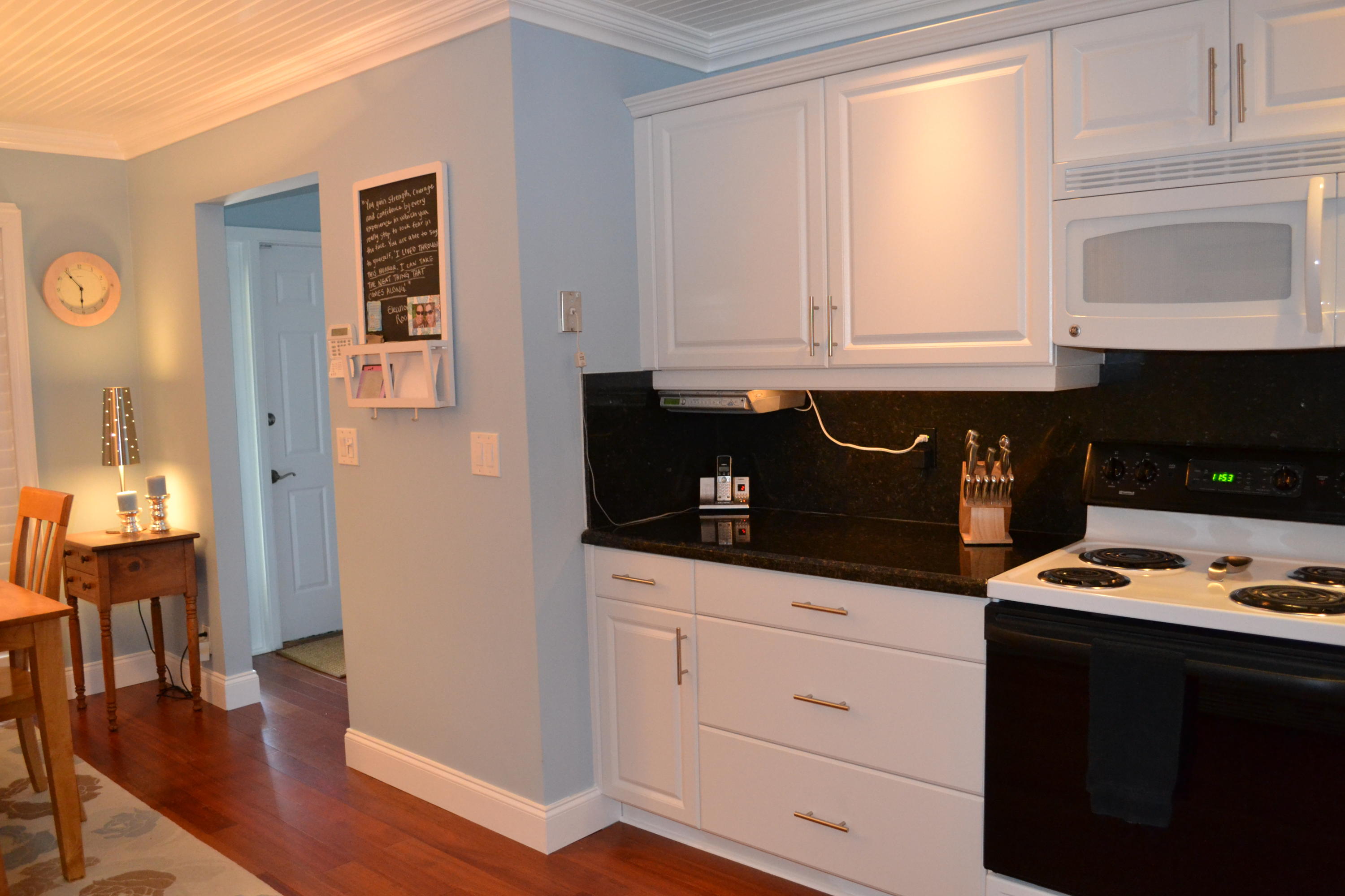 201 Southwest 1st Street, Unit 8 Boca Raton, FL 33432 - Photo 8 of 27 a kitchen with granite countertop white cabinets and black appliances