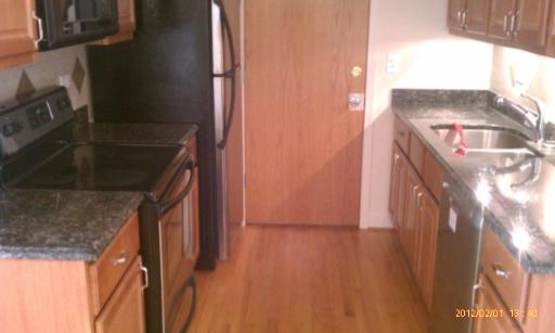 5025 North East River Road, Unit 2B Norridge, IL 60706 - Photo 7 of 9 a view of hallway with wooden floor