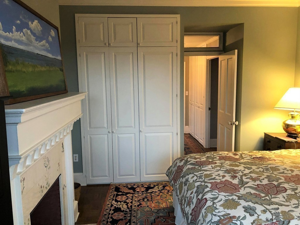 48 Beacon Street, Unit 9R Boston, MA 02108 - Photo 11 of 21 a bed room with a bed and a television