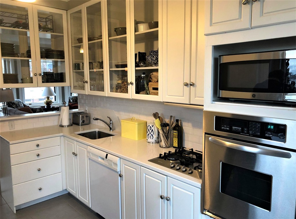 48 Beacon Street, Unit 9R Boston, MA 02108 - Photo 7 of 21 a kitchen with white cabinets and appliances