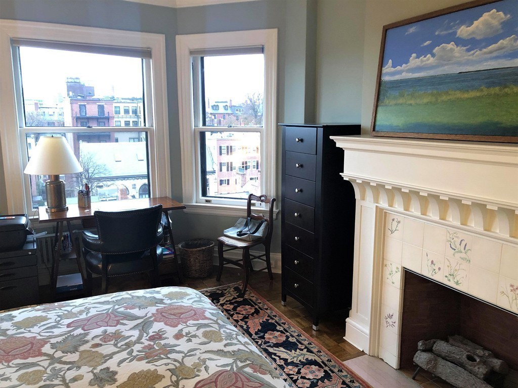 48 Beacon Street, Unit 9R Boston, MA 02108 - Photo 10 of 21 a bedroom with a bed and a fireplace