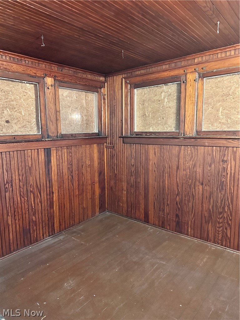 910 Cambridge Road Coshocton, OH 43812 - Photo 24 of 30 Bonus room featuring dark hardwood / wood-style flooring, wood ceiling, and wooden walls