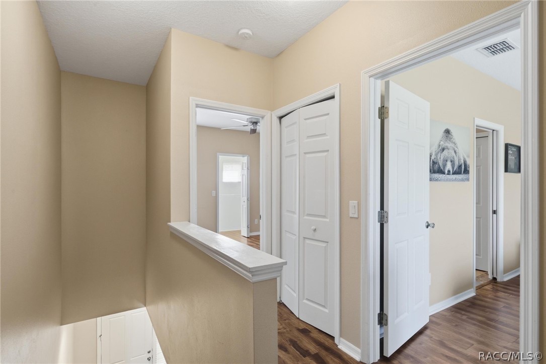 1598 West Spring Meadow Loop Lecanto, FL 34461 - Photo 14 of 74 Second Level Hallway To Primary & Guest Bedrooms Both w/EnSuite Baths