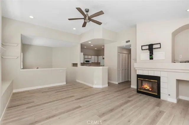 a view of a livingroom with wooden floor and a fireplace