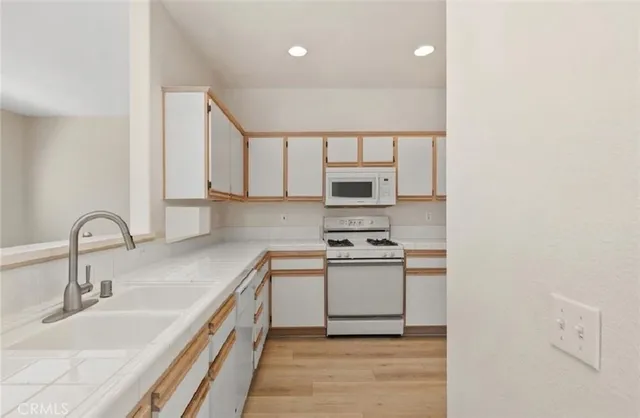 a kitchen with stainless steel appliances a sink stove and cabinets