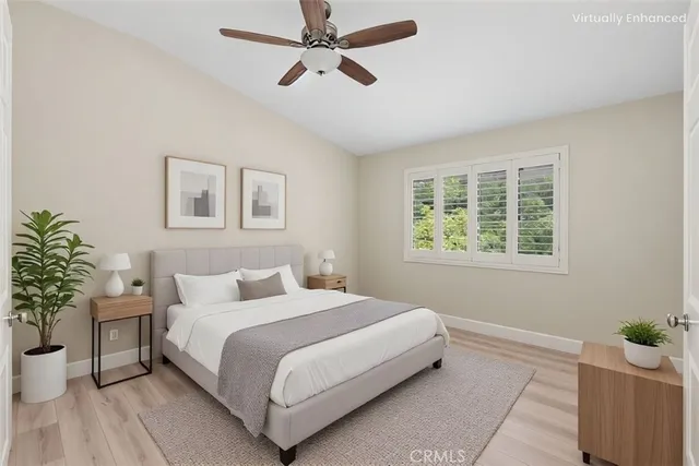 a bedroom with a bed and a potted plant