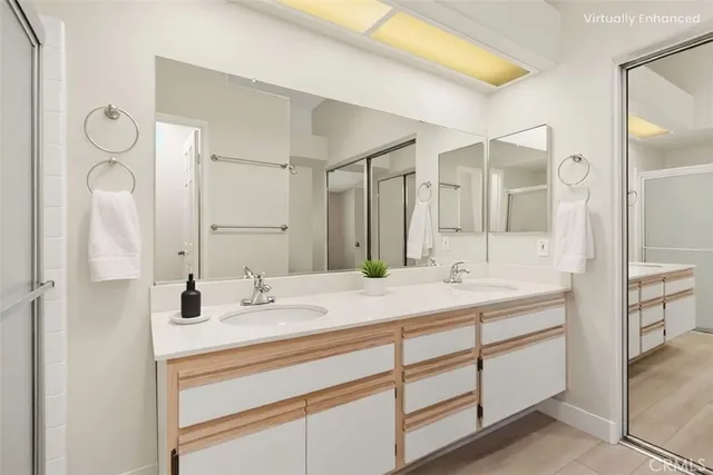 a bathroom with a sink double vanity and a mirror
