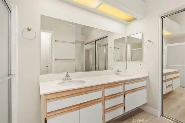 a bathroom with a sink double vanity and a mirror