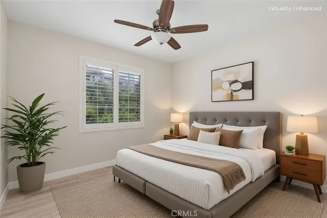 a bedroom with a large bed and a potted plant