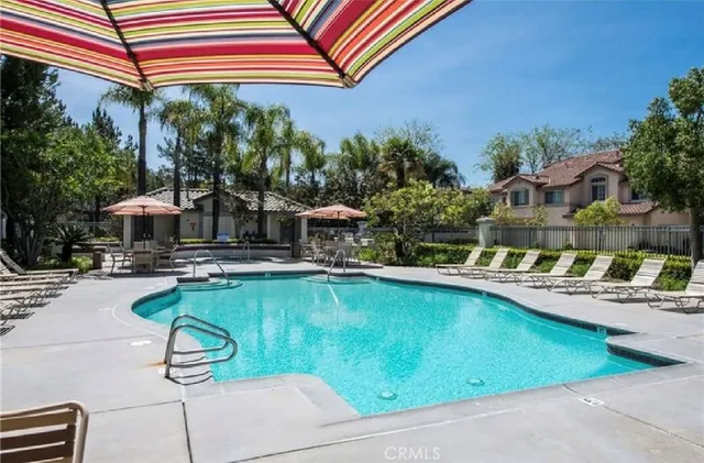a swimming pool with outdoor seating and yard